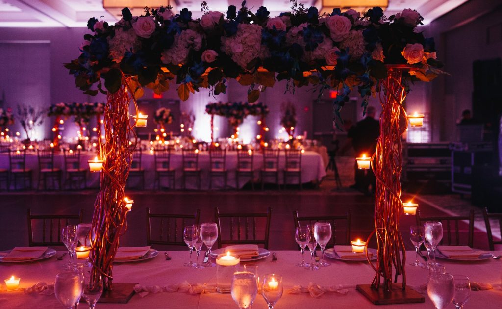 Beautiful pink decorated wedding serving with centerpiece and lightening candles